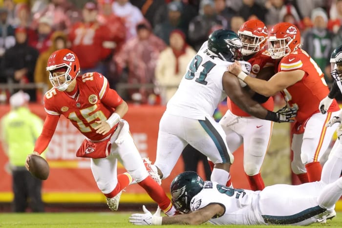Philadelphia Eagles rookie Jalen Carter takes down Kansas City Chiefs quarterback Patrick Mahomes with an ankle tackle.